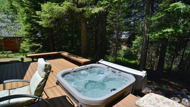 A hot tub on a wooden deck surrounded by trees. - Peace in the Pines: Woodland Oasis in Spring Mountain Ranch, Private Hot Tub (McCall)