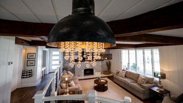 A spacious living room with a large chandelier, a fireplace, and a cozy seating area. - Beautifully renovated 3,800 sq ft house between 2 federal lakes  (Lyndon)