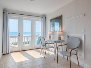 Enjoy stunning ocean views from the balcony, featuring a table and chairs for two.