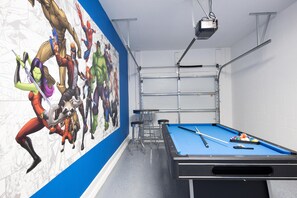 Enjoy a game of pool or relax with a projector movie night in this room featuring a pool table and a mural.