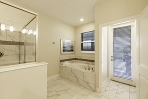 A bathroom with a glass shower enclosure, a marble-tiled vanity, and a door with blinds. - 8850ccd NON Renting 09/13/2021-the Retreat at Championsgate (Davenport)