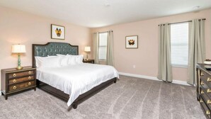 A bedroom with a large bed, two nightstands, a dresser, and a ceiling light. - C1573fd-the Retreat at Championsgate (Davenport)
