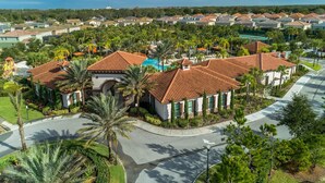 A residential area with a large house featuring a swimming pool, surrounded by palm trees and a curved road. - 5268oba-solterra Resort (Davenport)