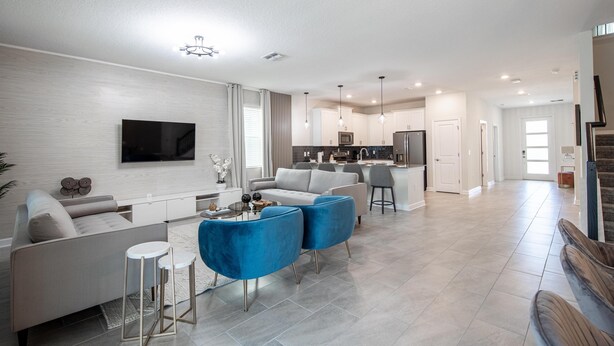 A modern living room with a flat-screen TV, a sofa, and a coffee table. - 840dsd-the Retreat at Championsgate (Kissimmee)