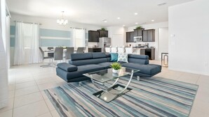 A modern living room with a sectional sofa, a glass coffee table, and a striped rug. - 6082bod-solterra Resort (Davenport)