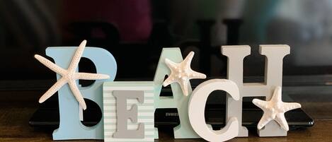 Decorative letters spelling "BEACH" with starfish decorations.