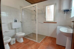 A bathroom with a toilet, bidet, shower, and sink. -  Solemare Azzurro with exclusive Pool,  (Balestrate, Sizilien)