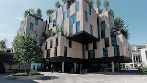 A modern building with a unique architectural design, featuring multiple levels and large windows. - Ruby Ella Hotel Cologne by IHG (Cologne)