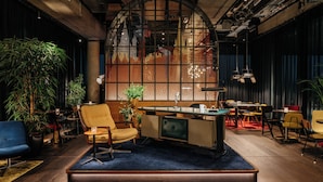 A modern interior with a bar area, seating, and large windows. - Ruby Ella Hotel Cologne by IHG (Cologne)