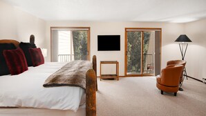A bedroom with a bed, a TV, a chair, and a lamp. - Casa Del Sol | 3BR+Loft Vail Townhome by Gore Creek, Pool (Vail)