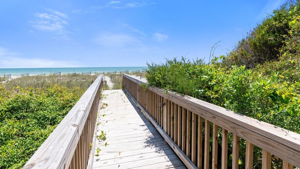 A wooden boardwalk leading to a beach with clear skies. - "Close Call" - Oceanfront Home, 4 Bedrooms / 3 Bathrooms (Holden Beach)