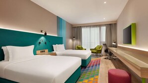 A hotel room with two beds, a desk, a chair, and a TV. - La Quinta by Wyndham Dubai Jumeirah (Dubai)