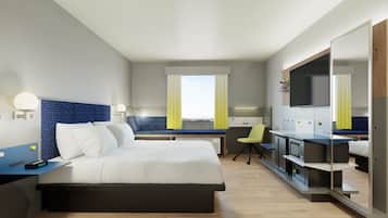Ein modernes Hotelzimmer mit Bett, Schreibtisch, Stuhl und Fernseher.