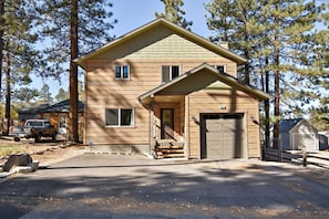 A two-story house with a garage, a front porch, and a driveway. - Village Retreat by Destination Big Bear : Custom Build, New Construction! Pool Table! Shuffleboard! Near Village! (Big Bear Lake)