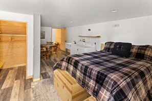 A bedroom with a bed, a wooden wardrobe, a desk, and a chair. - Mooncrest Manor by Destination Big Bear : Expansive Mountain Views! Large Family Spaces! Pet Friendly! Game Room! (Big Bear Lake)