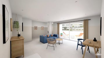 Una sala de estar moderna con un sofá azul, una mesa de comedor y un amplio ventanal corredera que da a un área exterior.