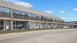 A modern building with a flat roof and large windows. - 4 Person Holiday Home in Fano (Fano)