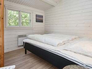 A room with a bed, a window, and a wall-mounted picture. - 5 Person Holiday Home in Fano (Fano)
