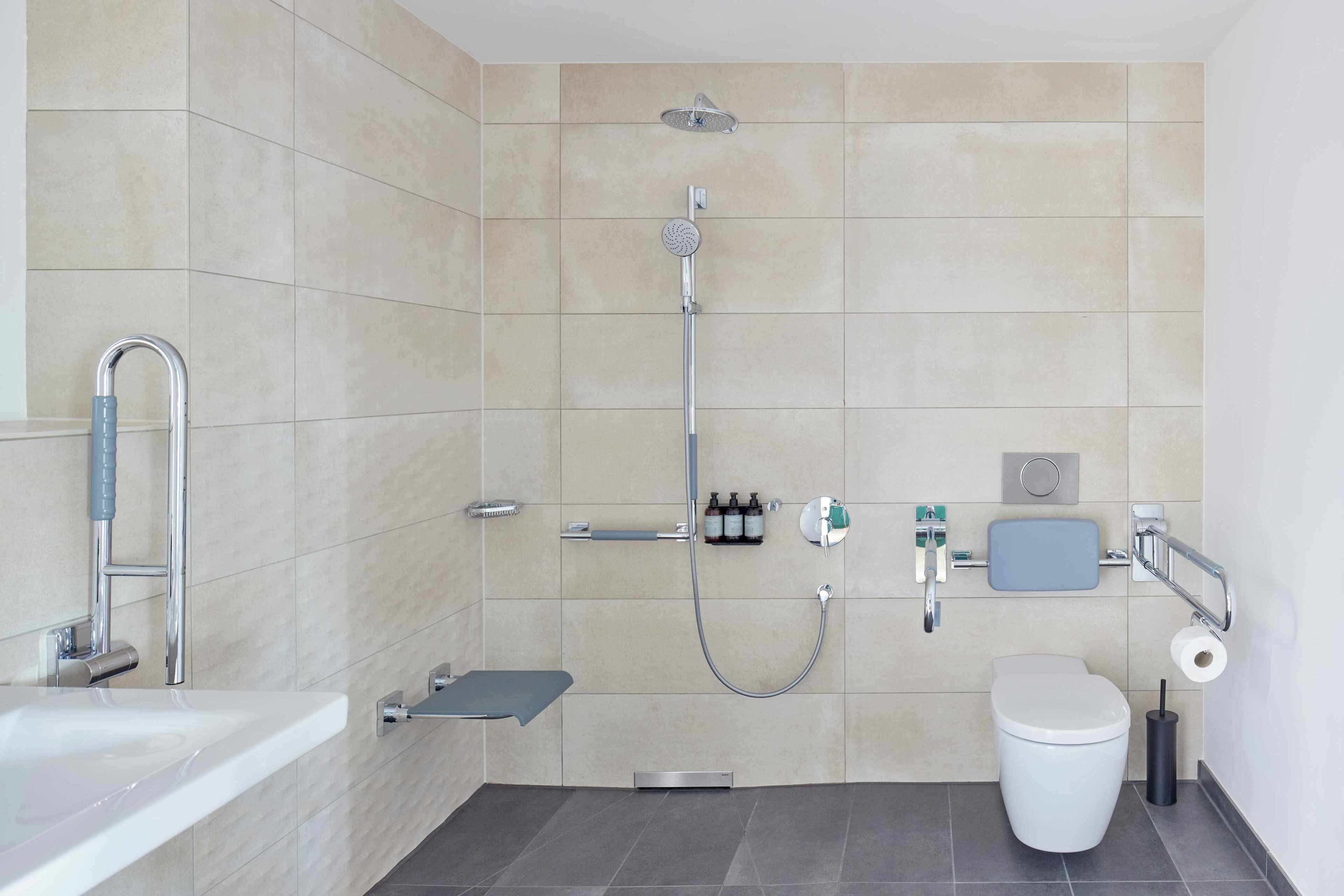 A modern bathroom with a shower, toilet, and sink.