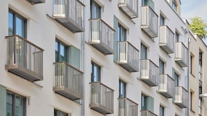 A multi-story building with balconies and windows. - Schwan Locke (Munich)
