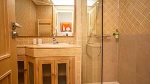 A bathroom with a sink, mirror, and shower. - Marina del Castillo 319 (Manilva)