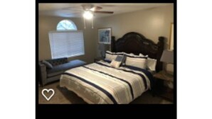 A bedroom with a bed, a nightstand, a desk, and a window with blinds. - Your Second Home. Big 2 Bedroom and 2 bathroom. (Clearfield)