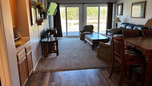 A spacious living area with a fireplace, a dining table, and a comfortable seating arrangement. - Rum River Retreat! Clean & Cozy on 15 acres! (Cambridge)