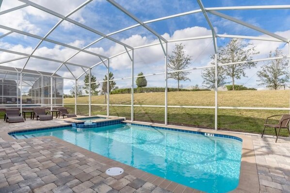 A covered outdoor swimming pool with a clear view of the surrounding landscape.