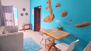Un soggiorno con un divano, un tavolino e una parete blu.