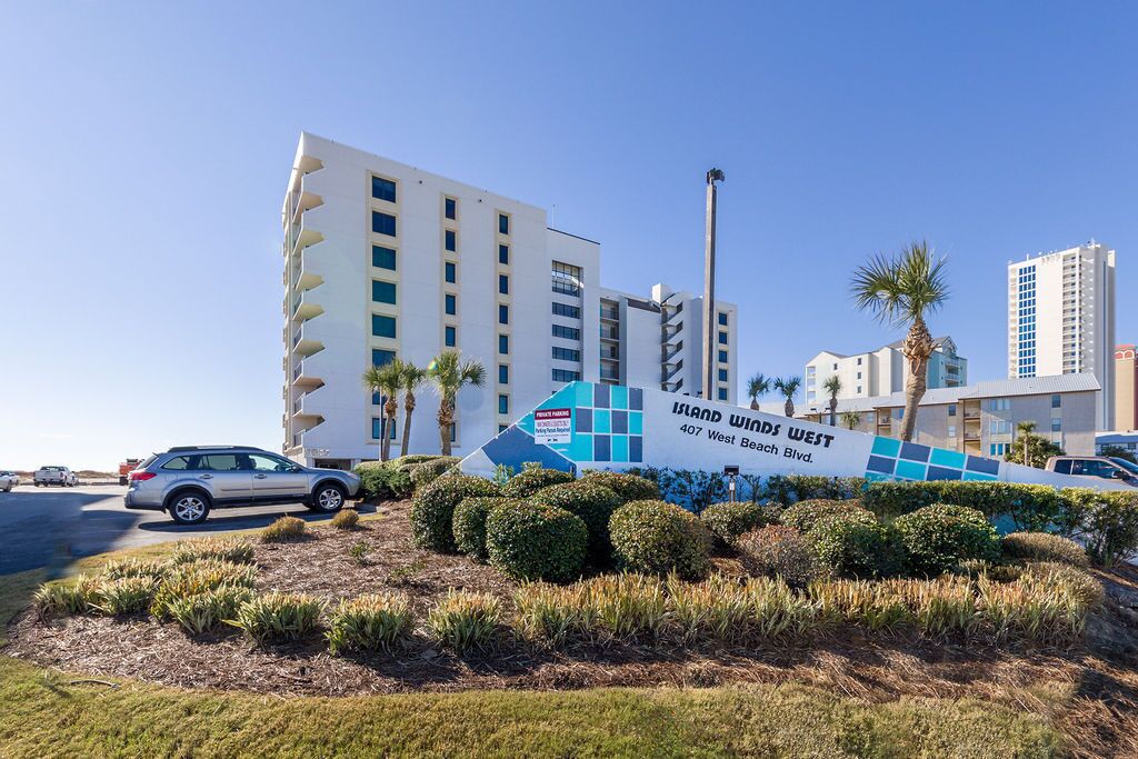 Segnale dell'hotel Island Winds West, con un edificio moderno sullo sfondo.
