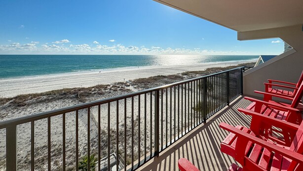 A balcony with a view of a beach and ocean. - Island Winds West 580 | Walk to HangOut! | Heated Pool! | Beach Getaways (Gulf Shores)