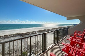 Een balkon met uitzicht op een strand en zee.