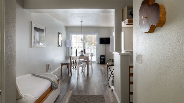 A modern bedroom with a bed, a desk, and a dining area. - Outpost: Balsam Lodge A3 - Aspens Location! (Wilson)