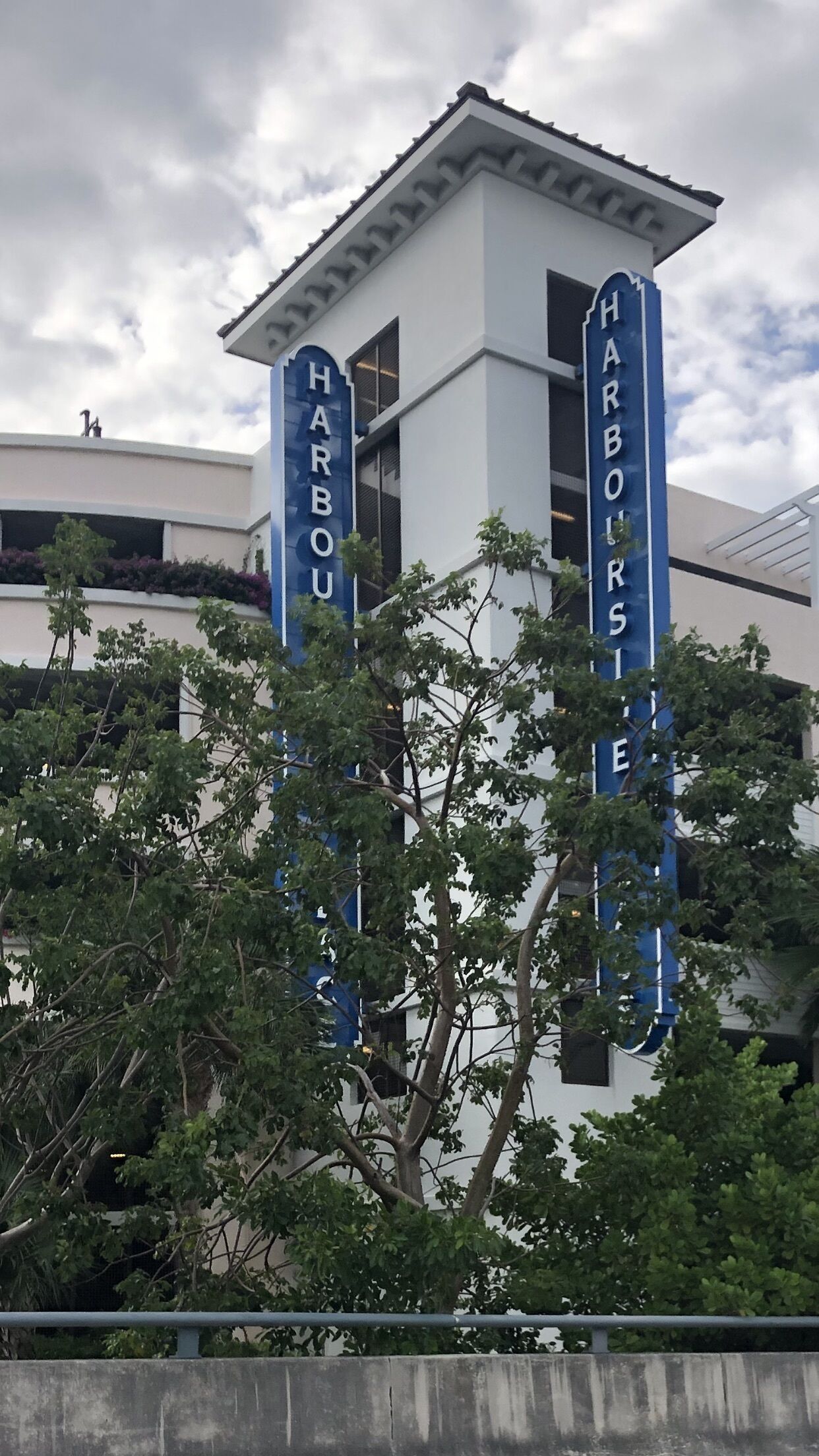 A building with a sign reading "Harbour Suites".