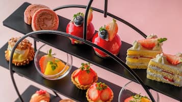 A multi-tiered dessert display with various types of pastries and desserts.