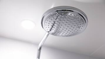 A modern showerhead with a circular design and multiple nozzles.