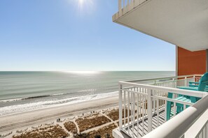 A balcony with a view of the beach and ocean. - Myrtle Beachfront Bliss: Pools, Views & SkyWheel! (Myrtle Beach)