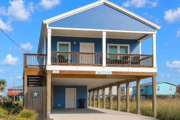 Pull up in the spacious driveway on the quiet street that dead ends at the beach