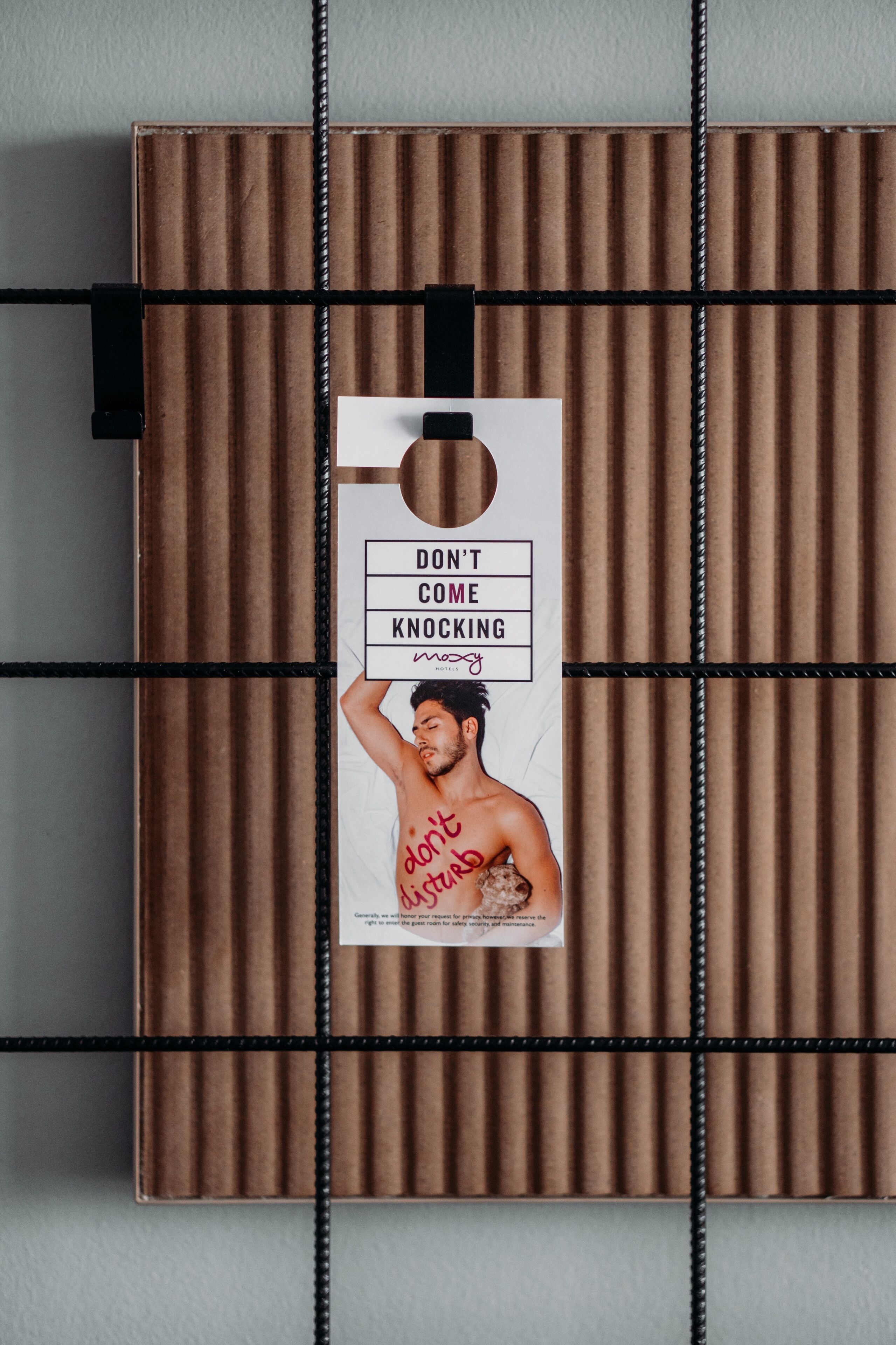 A brown box with a tag that reads "DON'T COME KNOCKING" and a man with the text "don't disturb" on his shirt.