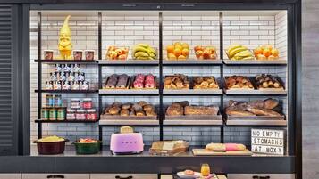 Mostrador de panadería con diversos productos horneados y una decoración de gnomo.