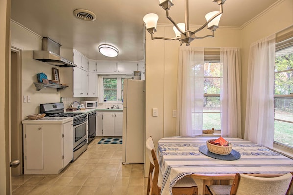 Enjoy cooking in the well-equipped kitchen with a stove, oven, microwave, and refrigerator, and dine by the window with a view.