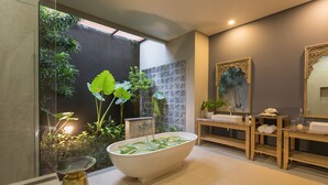 A modern bathroom with a freestanding bathtub, a wooden vanity, and a large mirror. -  Villa Daun 2 Canggu by Premier Hospitality Asia (Canggu)