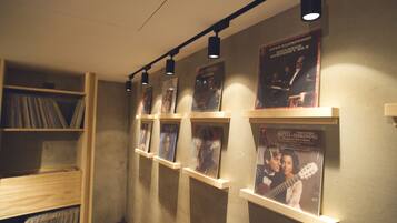 A music-themed display with posters and vinyl records on shelves.