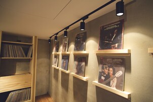A music-themed display with posters and vinyl records on shelves.
