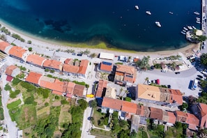 Luchtbeeld van een kustplaats met gebouwen, een strand en boten.