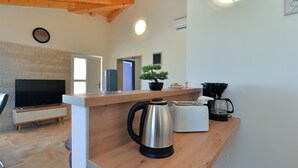 A modern kitchen with a wooden countertop, a kettle, a coffee maker, and a bonsai tree. - House 2065/32772 (Istria - Žminj), 20000m from the beach (Žminj)