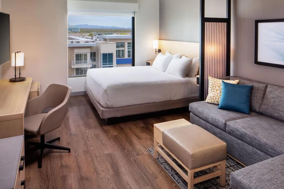 hypo-allergenic bedding, desk, laptop workspace, blackout curtains