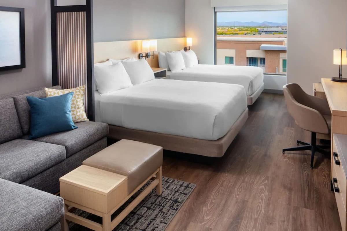 Hypo-allergenic bedding, desk, laptop workspace, blackout drapes