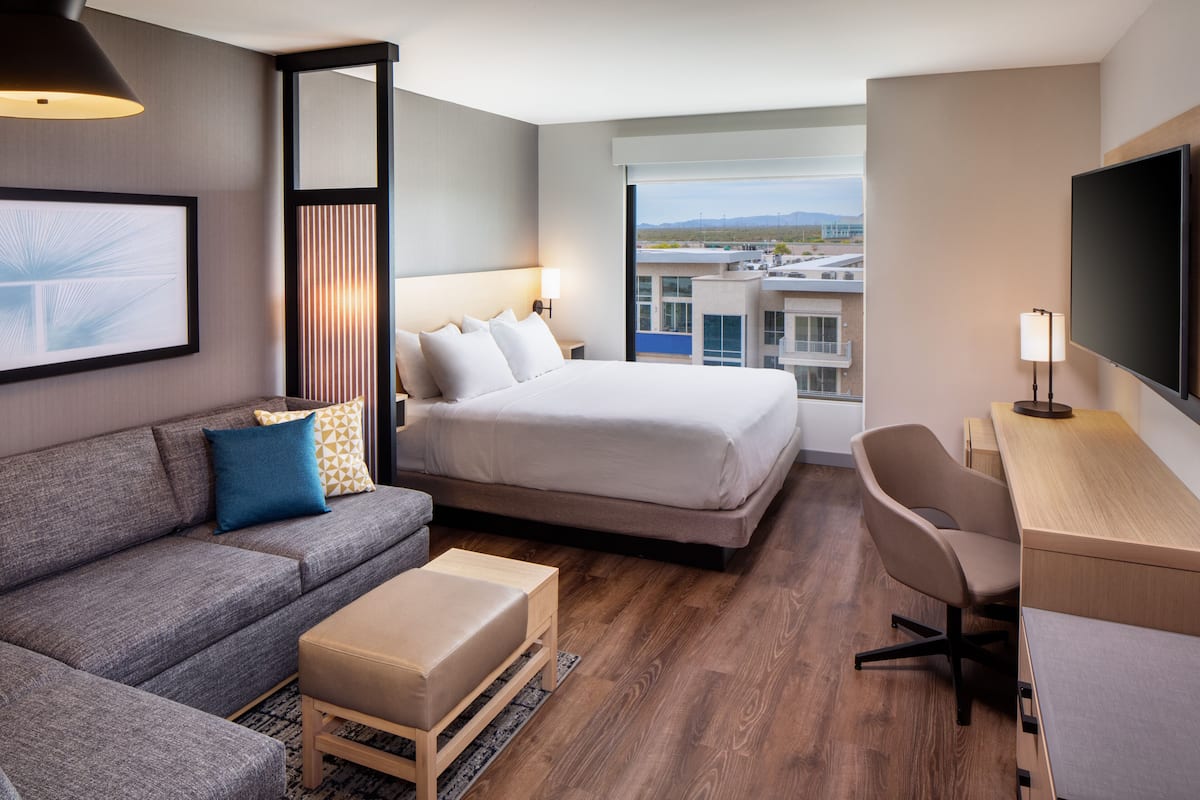 hypo-allergenic bedding, desk, laptop workspace, blackout curtains