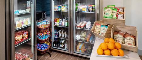 A refrigerated display with various food items and beverages.